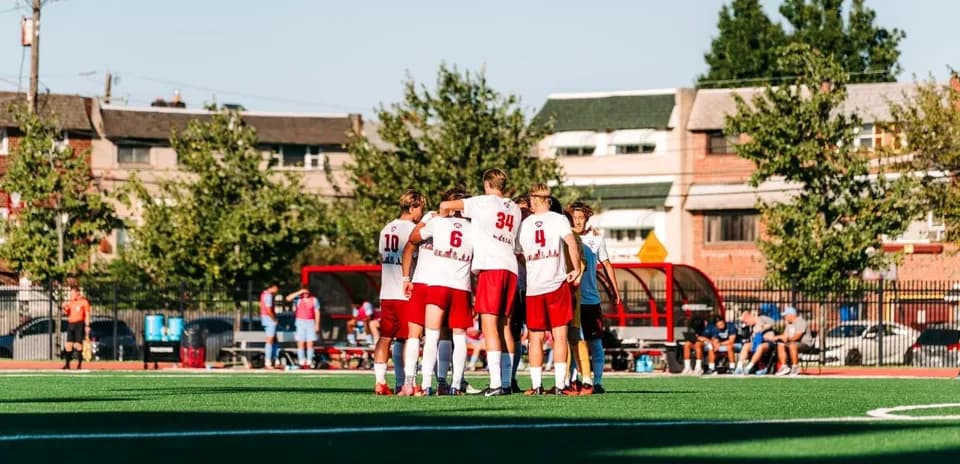 Players huddled together before soccer match