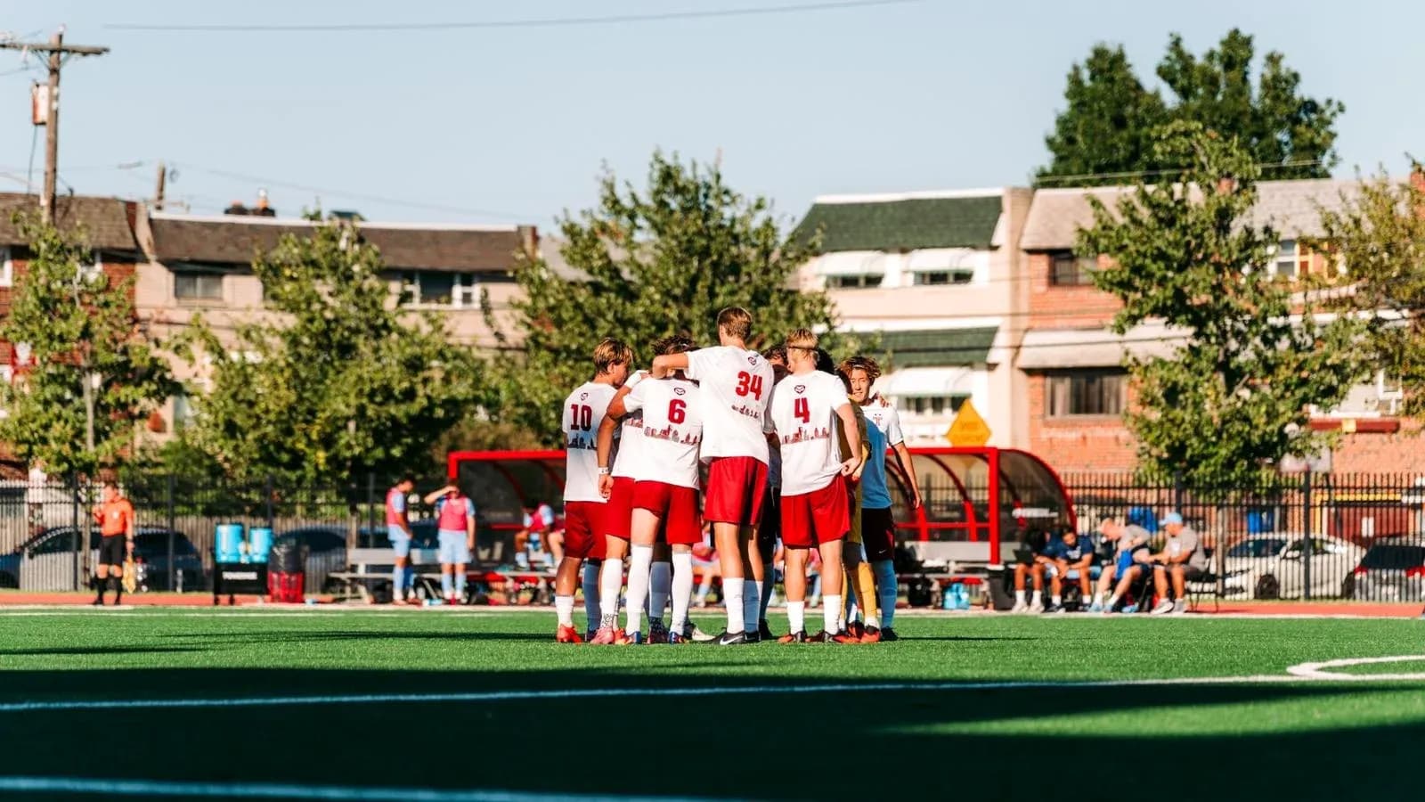 Players huddled together before soccer match