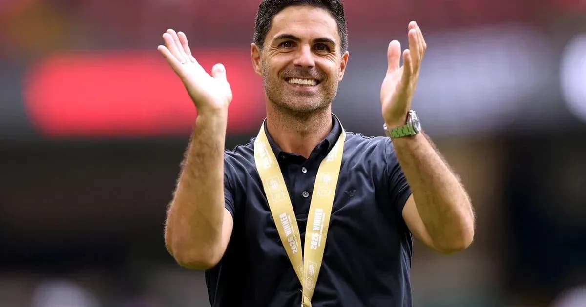 Coach celebrating with hands raised at event
