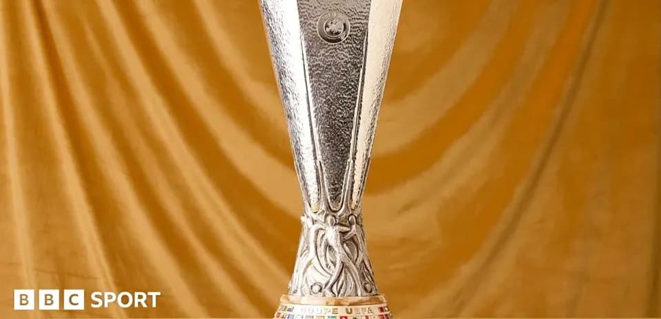 UEFA Europa League trophy on golden background