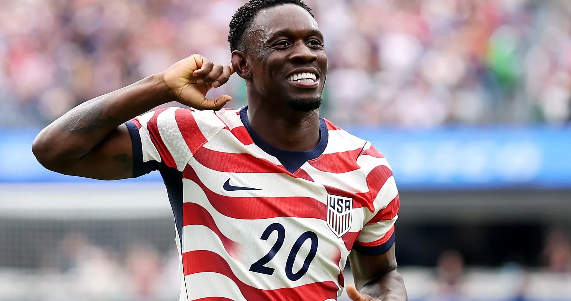 Player celebrating in USA striped jersey during match