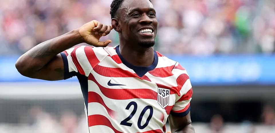 Player celebrating in USA striped jersey during match