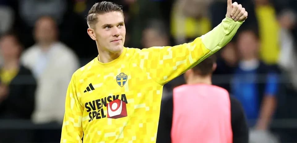 Goalkeeper in yellow jersey giving thumbs up