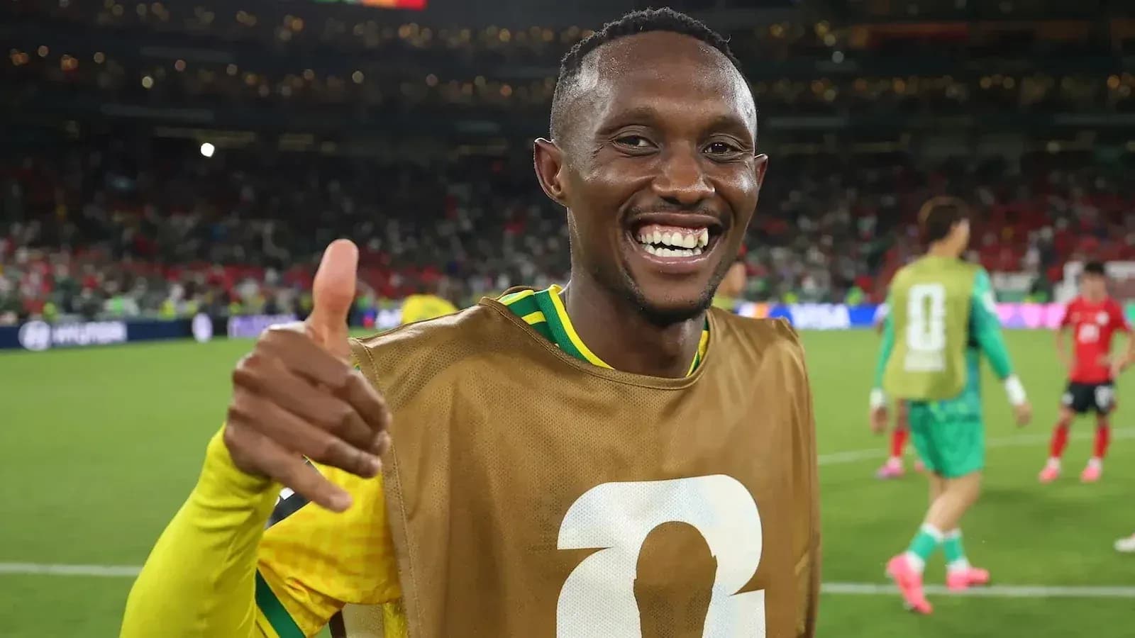 Player celebrating with a thumbs up on field