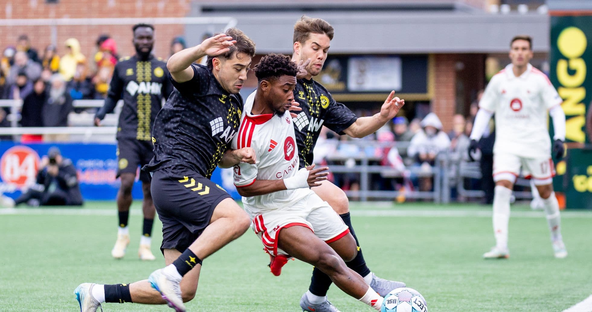Two players contesting the ball during match