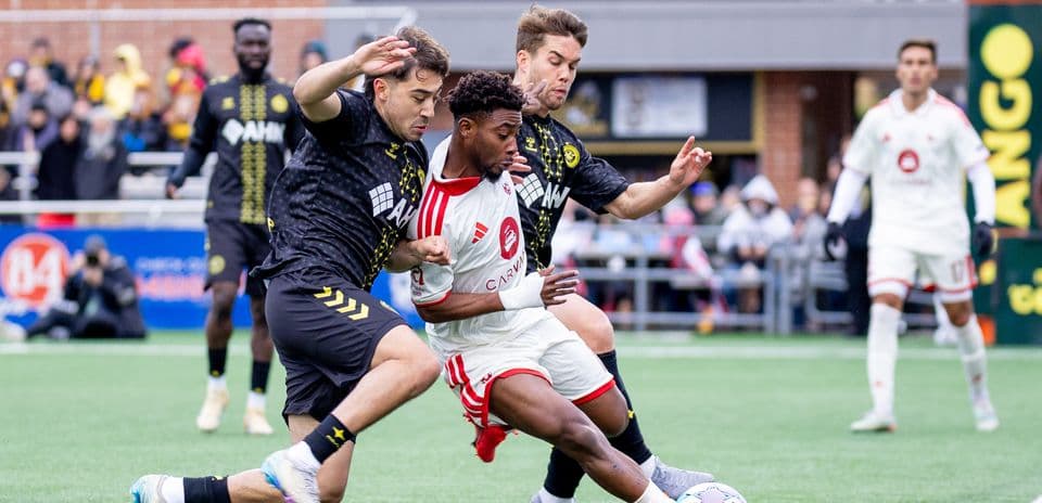 Two players contesting the ball during match