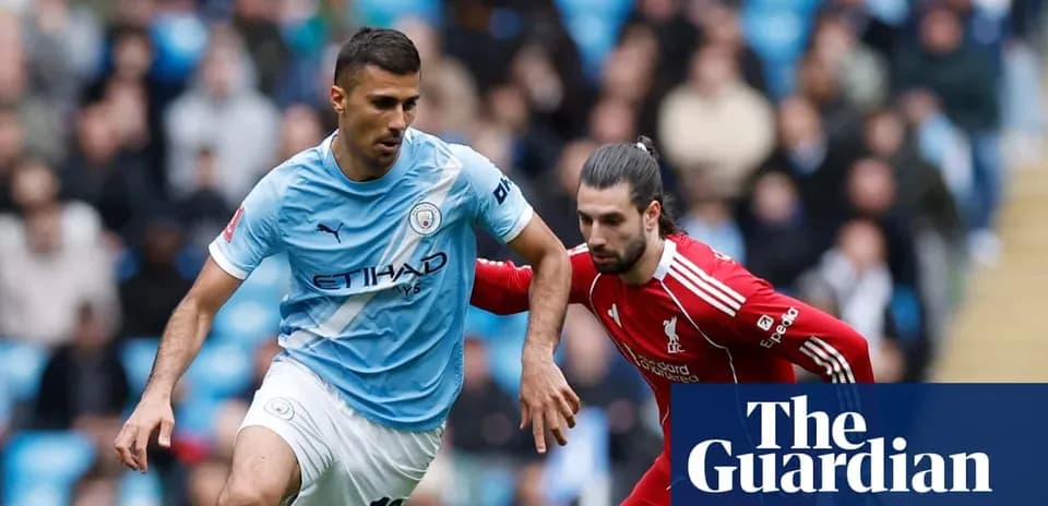 Manchester City player evading Liverpool opponent during match