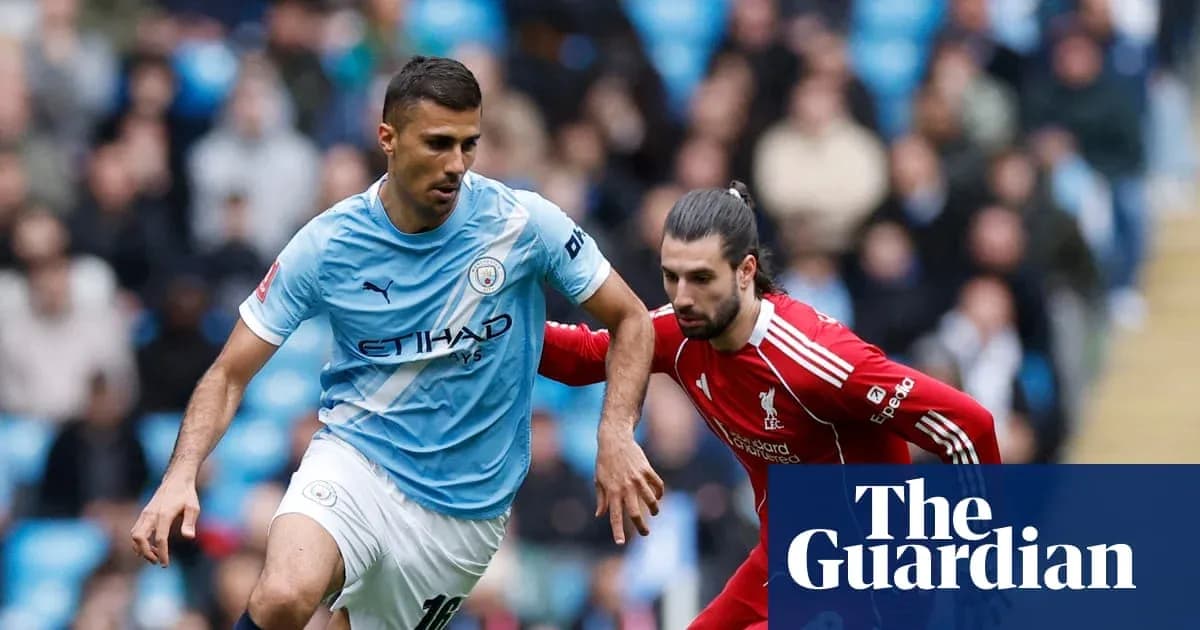 Manchester City player evading Liverpool opponent during match
