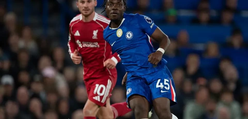 Chelsea player dribbling past Liverpool opponent