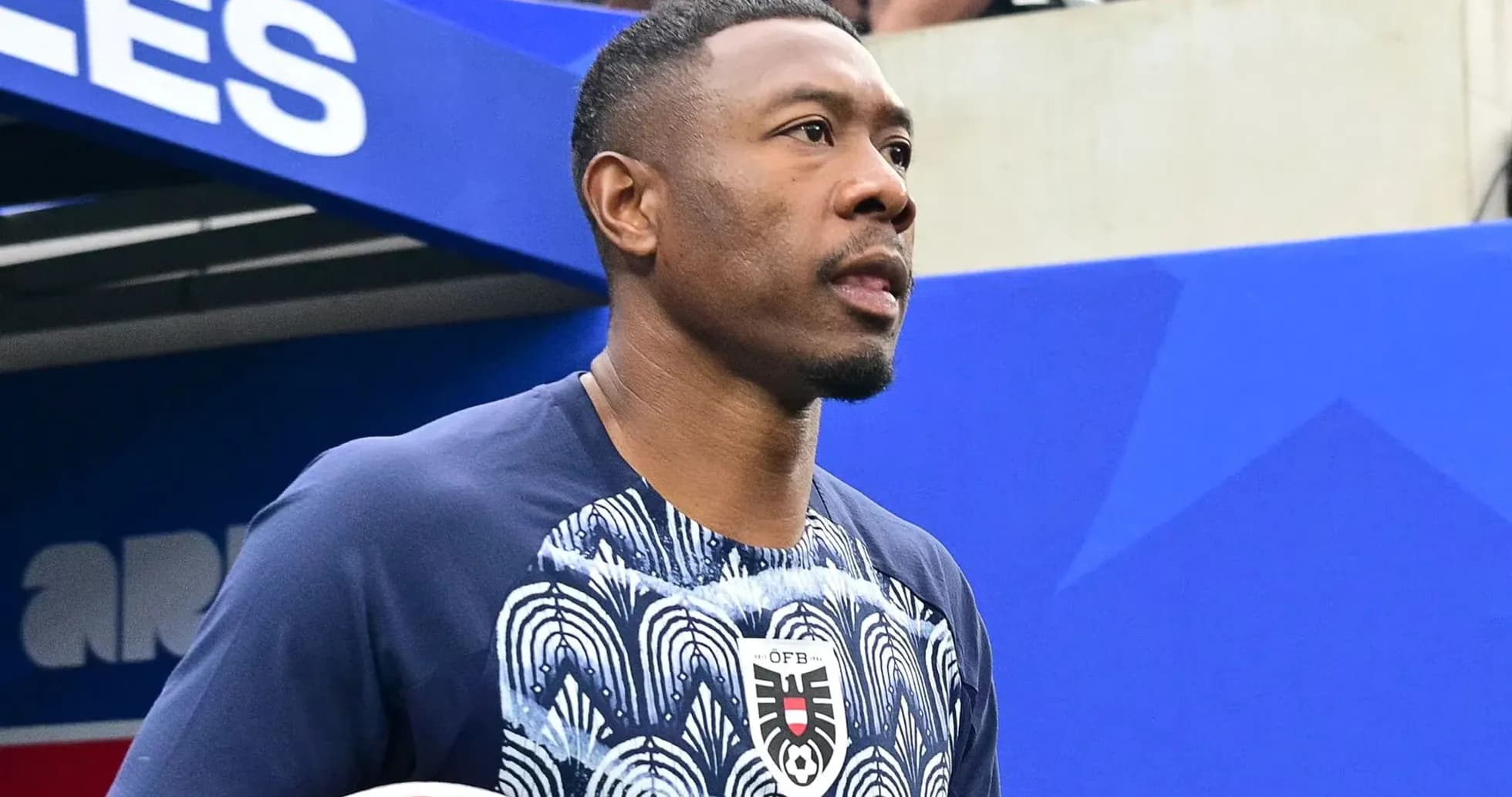 Player entering the field with a soccer ball