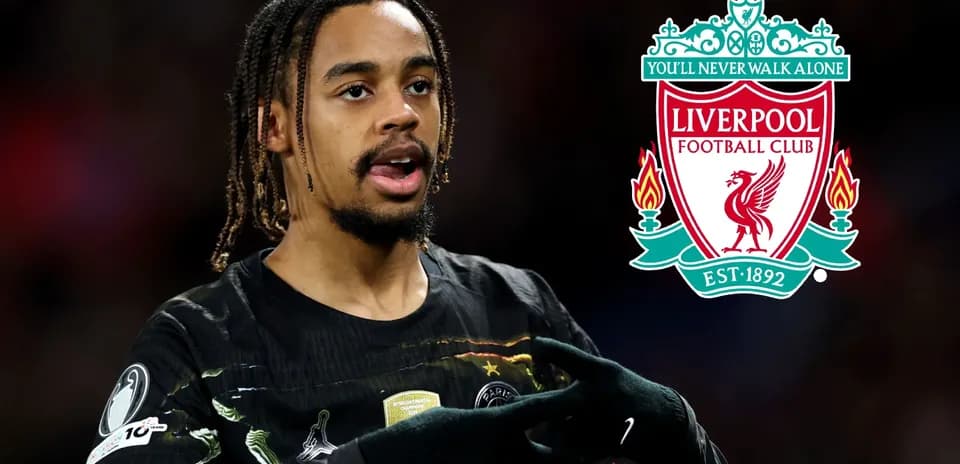 Player gesturing with Liverpool logo in background