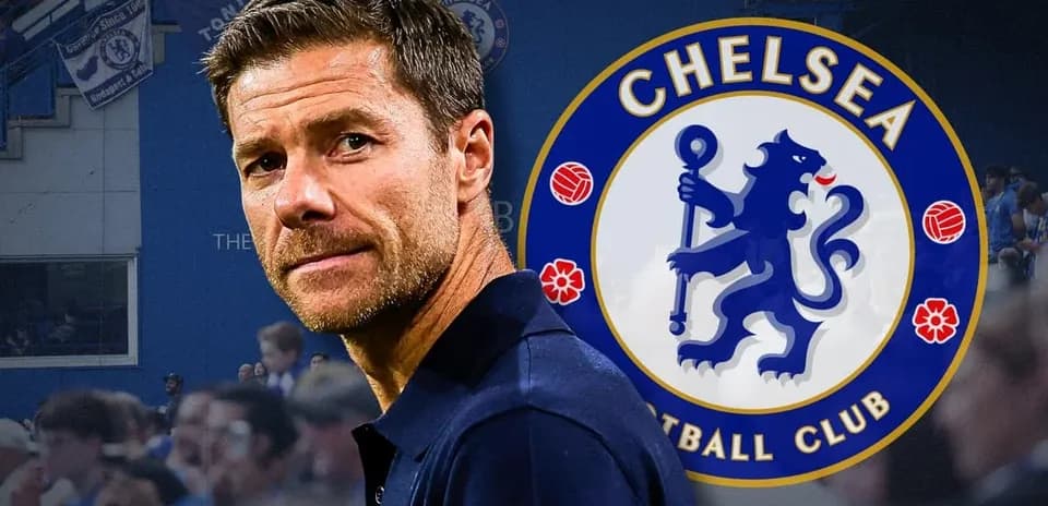 Manager in front of Chelsea FC logo and fans