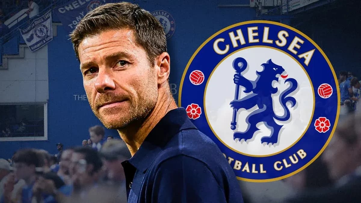 Manager in front of Chelsea FC logo and fans