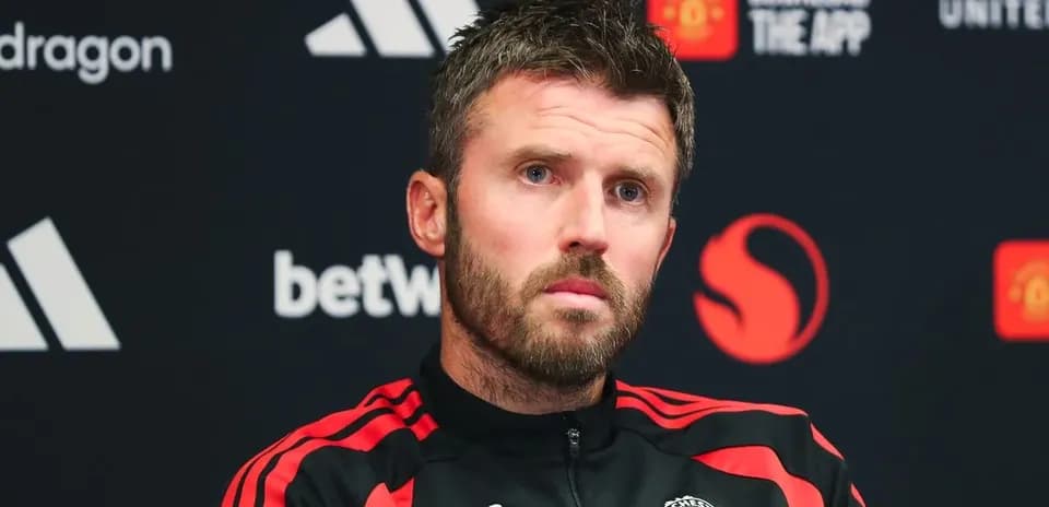 Manager at press conference with Manchester United branding
