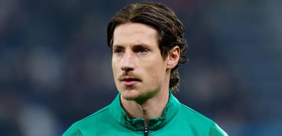 Goalkeeper in green kit during pre-match warm-up