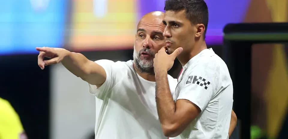 Coach discussing strategy with player on the sidelines