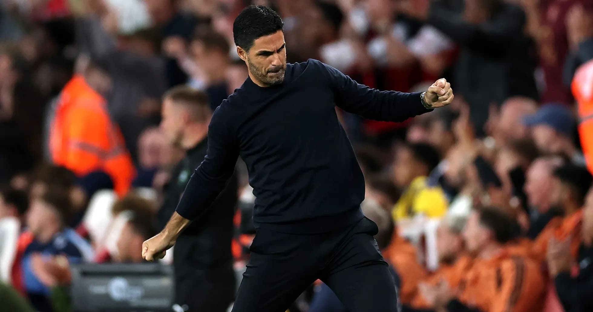 Manager celebrating during a match with fans