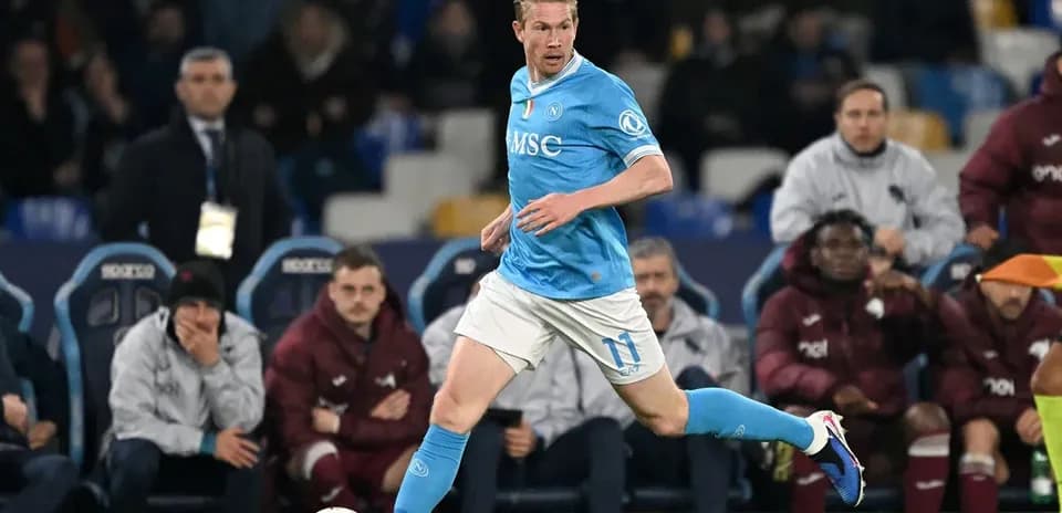 Player in blue jersey dribbling ball during match