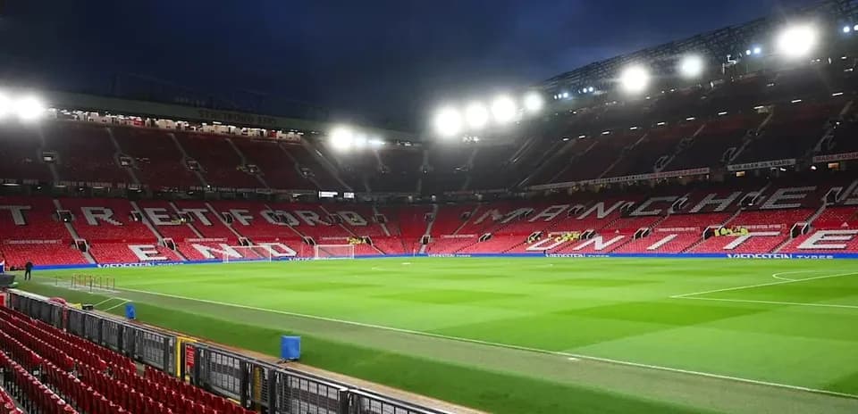 Empty Old Trafford stadium with illuminated seating