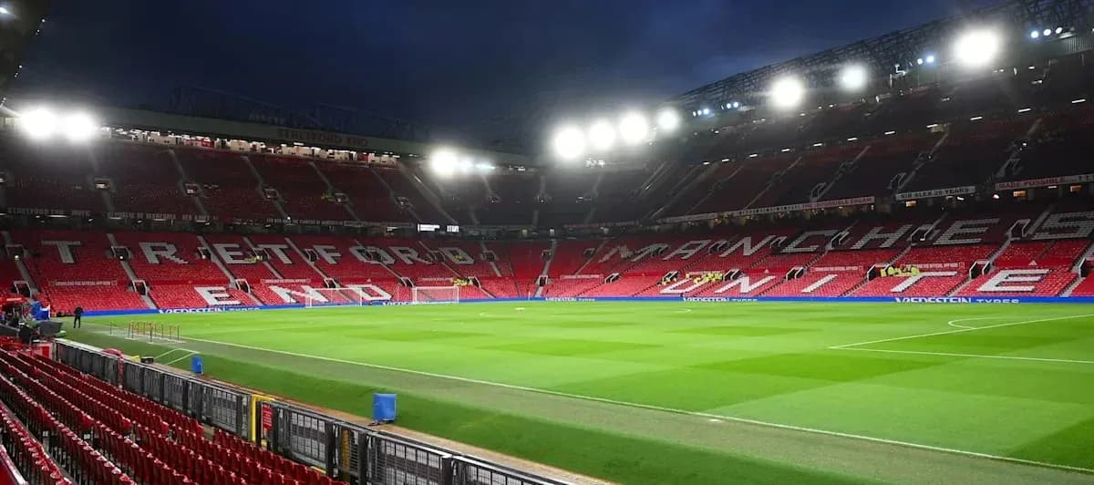Empty Old Trafford stadium with illuminated seating