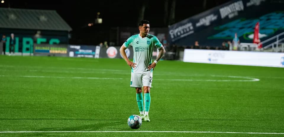 Player preparing for a free kick in football match
