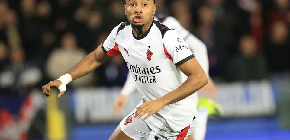 Player wearing AC Milan jersey during match action