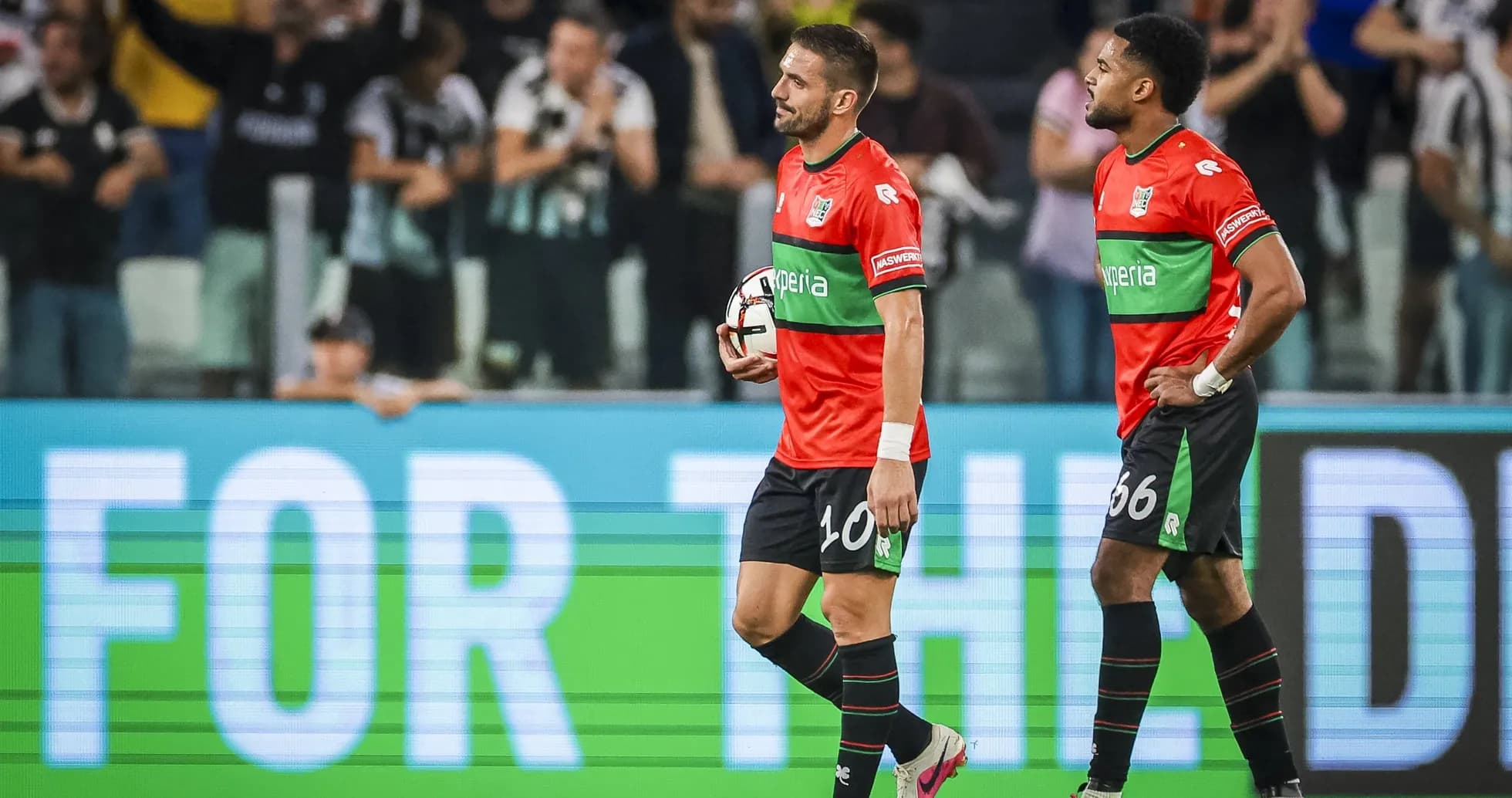 Two players walking off the field after match