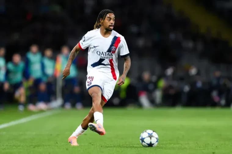 Player in PSG kit dribbling the ball during match