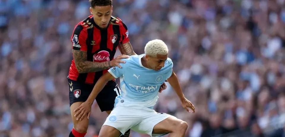 Bournemouth player tackling Manchester City player