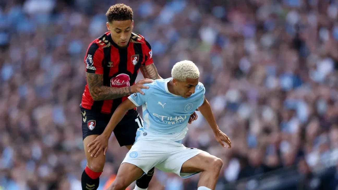 Bournemouth player tackling Manchester City player
