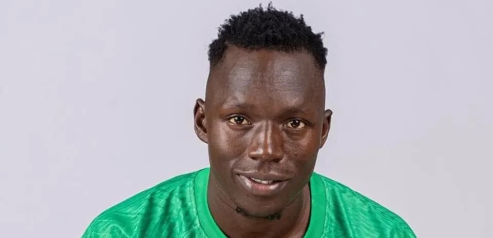 Goalkeeper posing in green kit for portrait