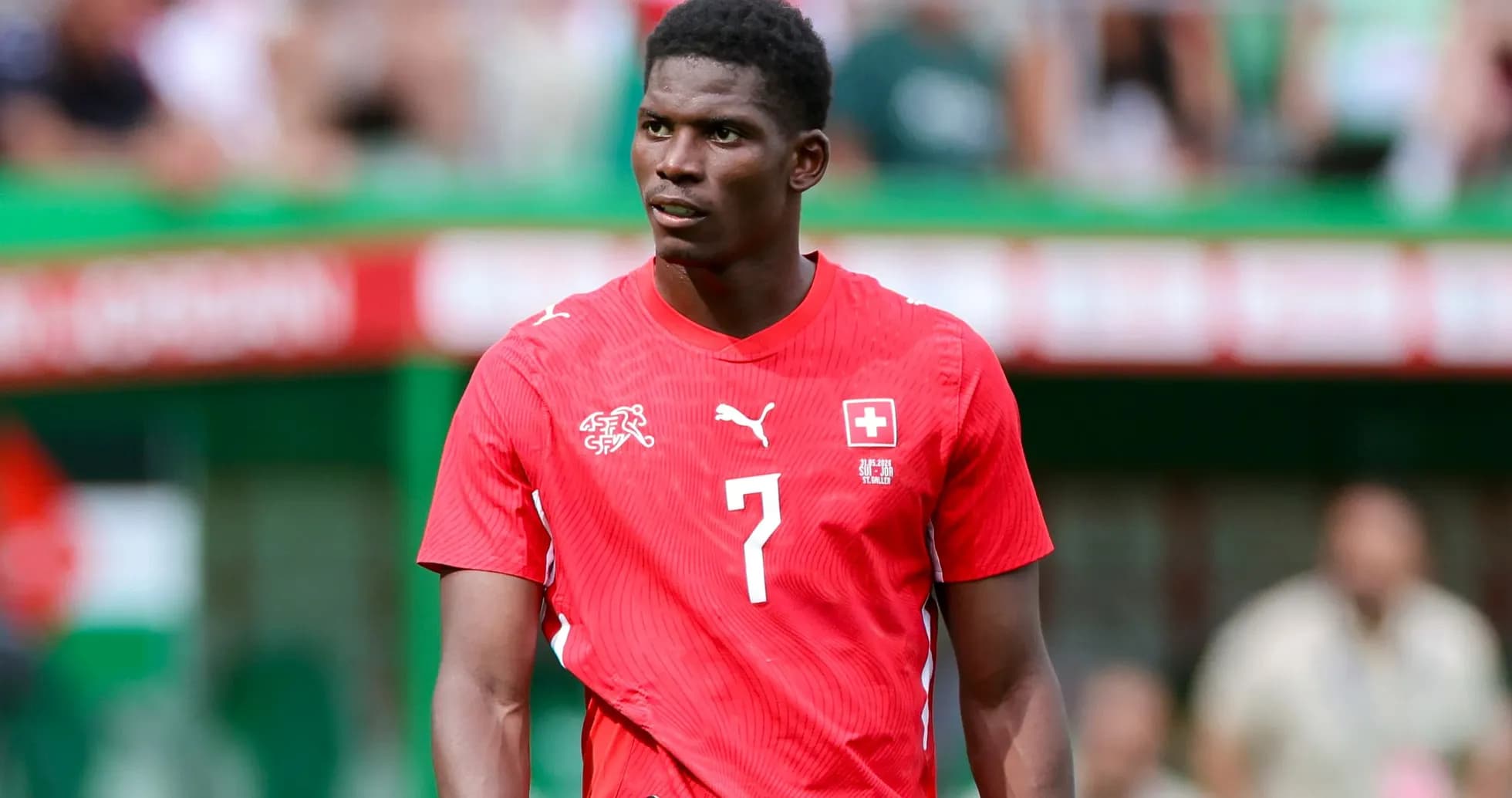 Player wearing red Switzerland jersey on field