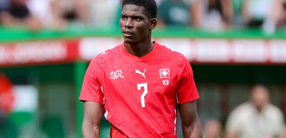 Player wearing red Switzerland jersey on field