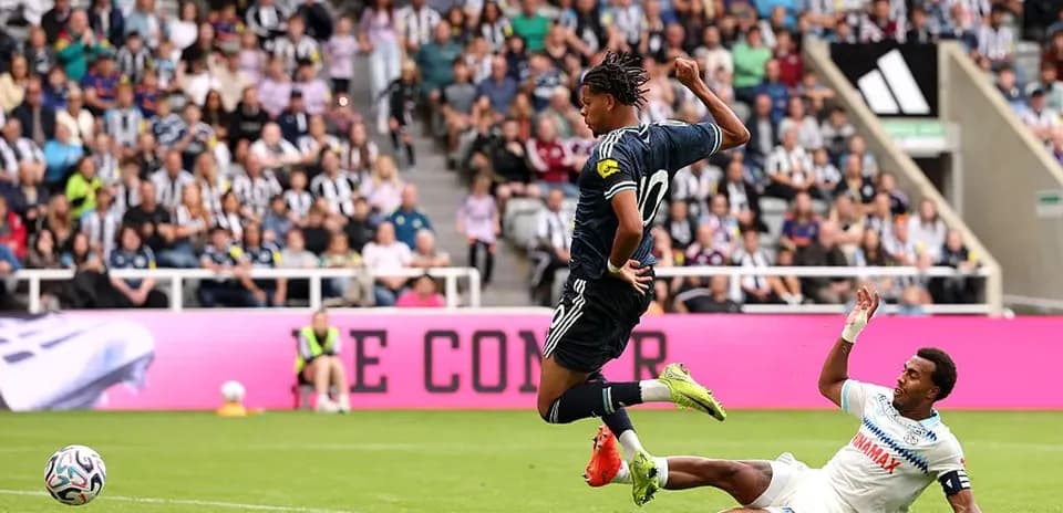 Player evading a tackle during a football match