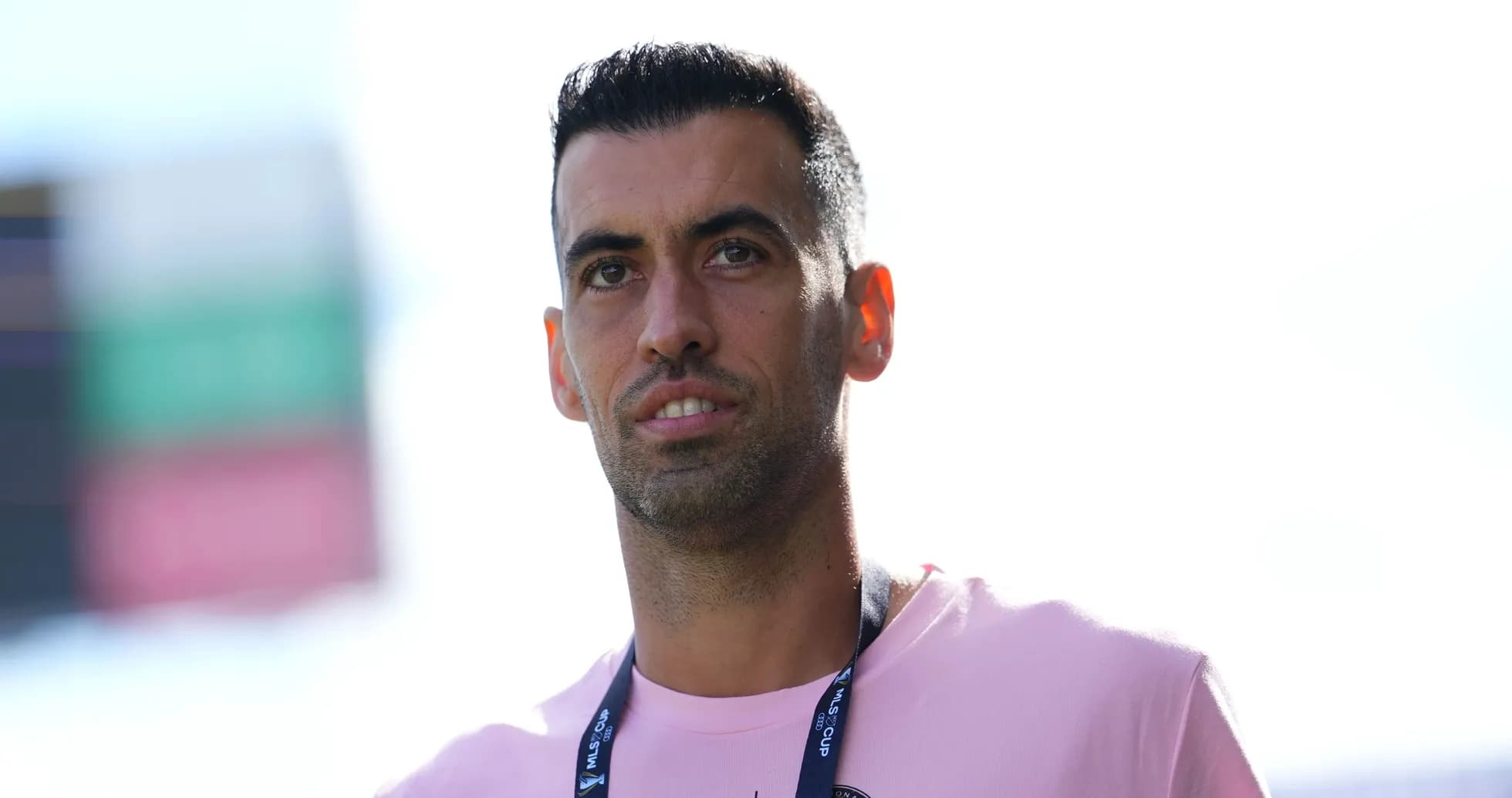 Player in a pink shirt with lanyard at event