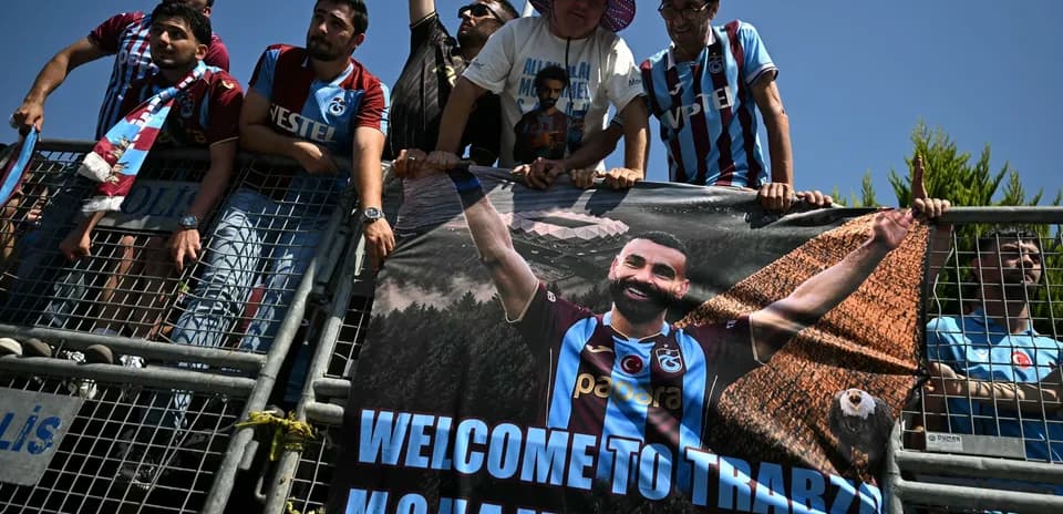 Fans holding banner welcoming player to Trabzon