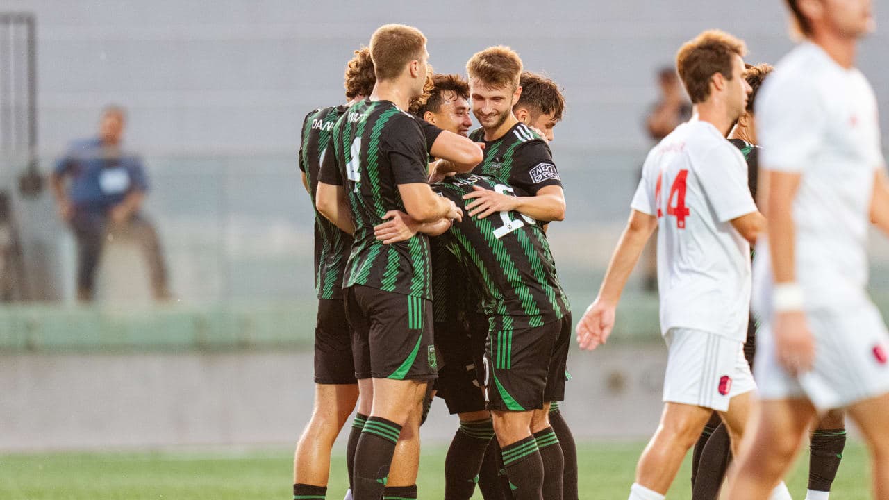 Players celebrating a goal during match