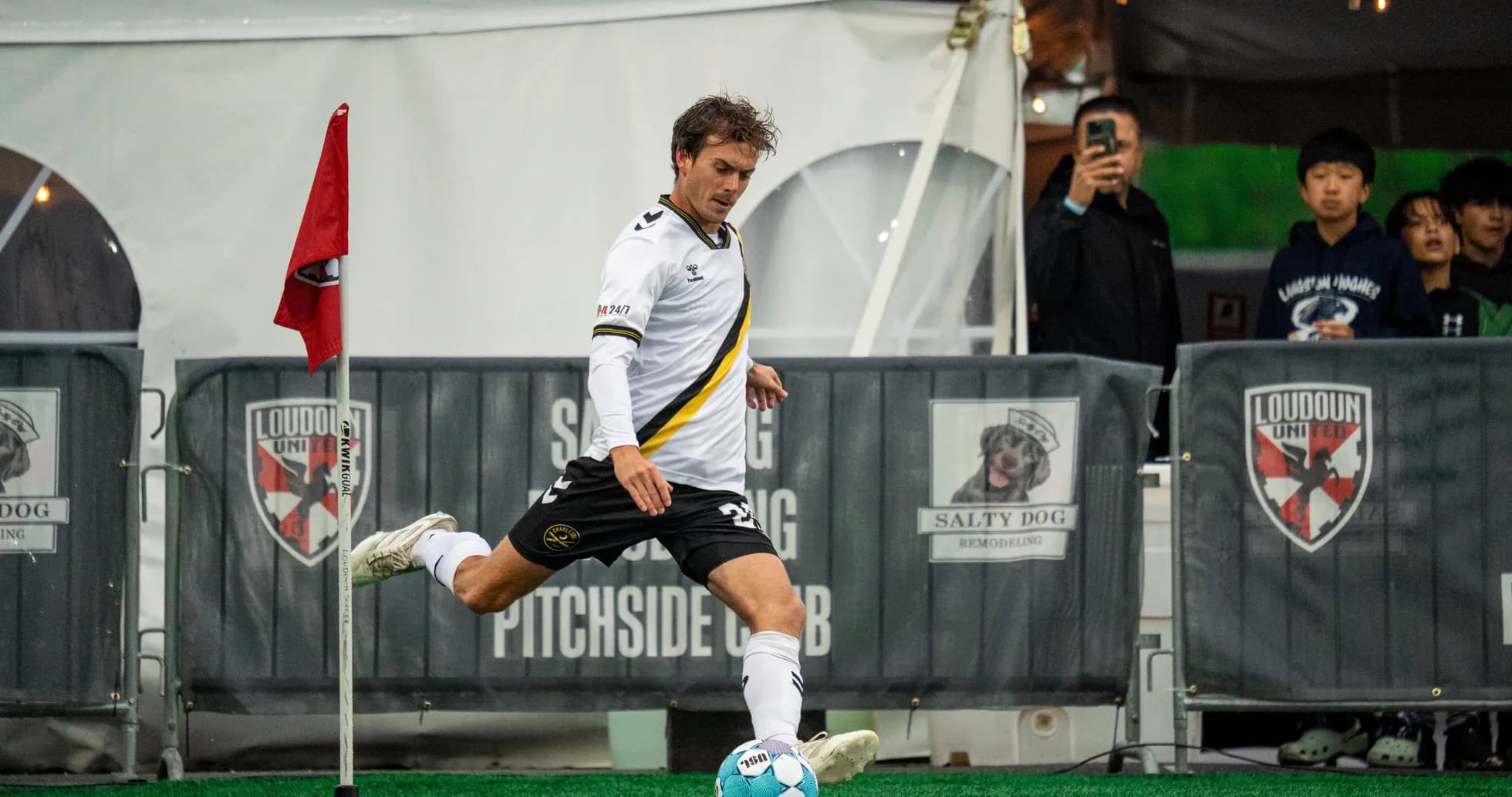 Player taking a corner kick during match