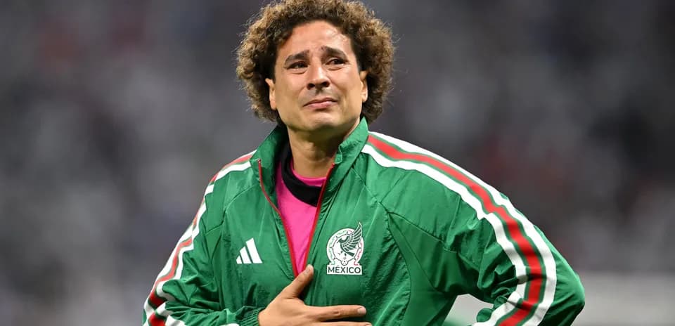Goalkeeper wearing green jacket, hand on chest