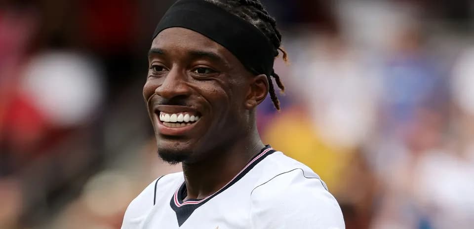 Soccer player smiling during match warm-up