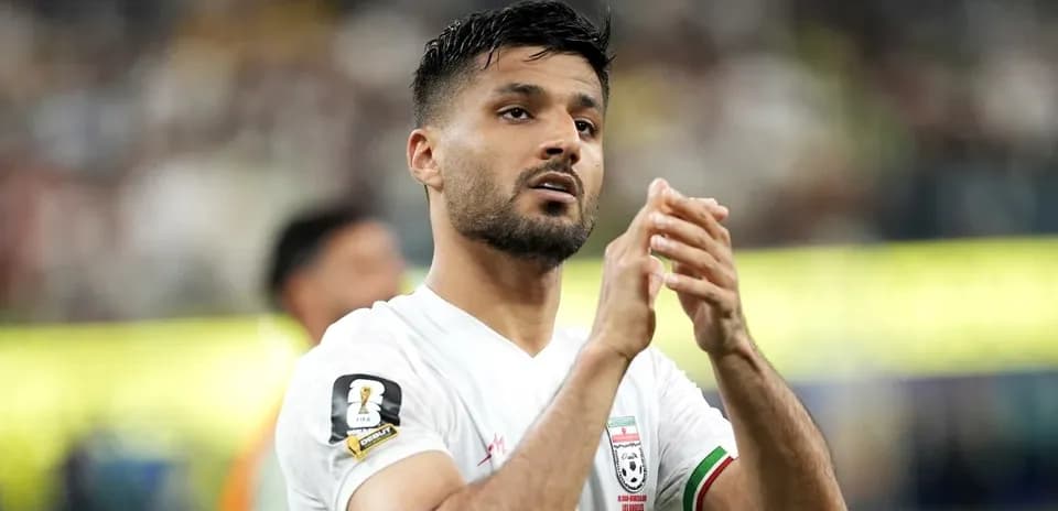 Player clapping after match in white jersey