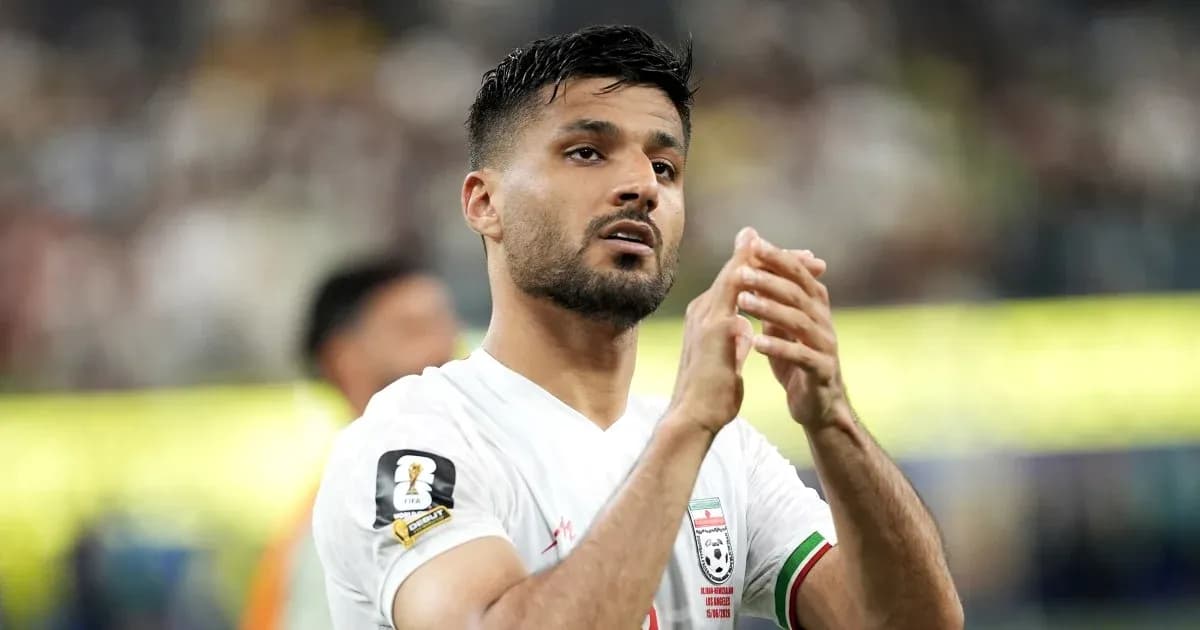 Player clapping after match in white jersey