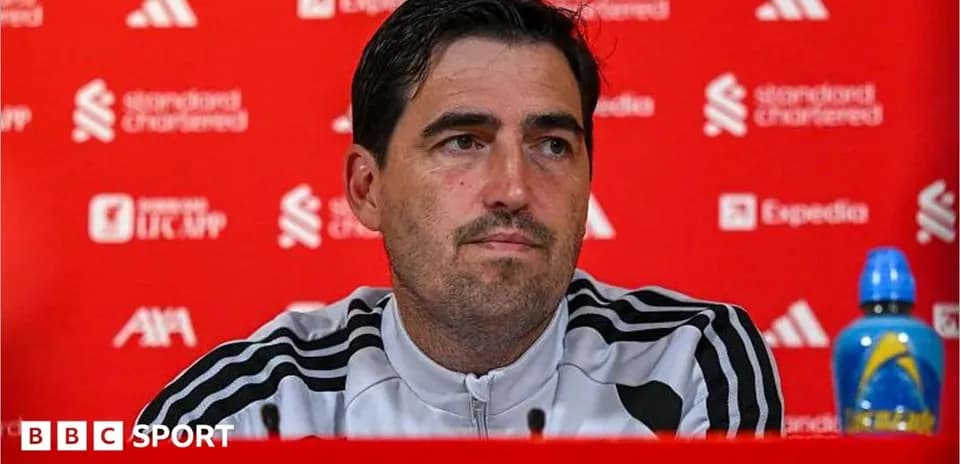 Manager speaking at press conference with backdrop