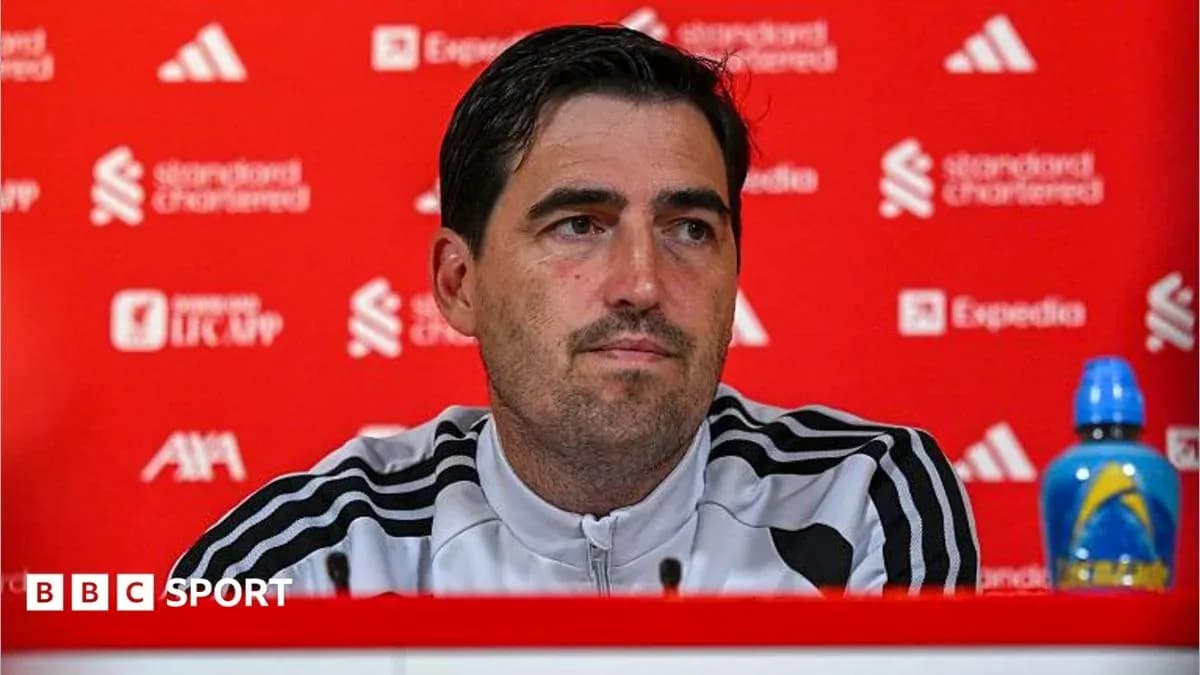 Manager speaking at press conference with backdrop
