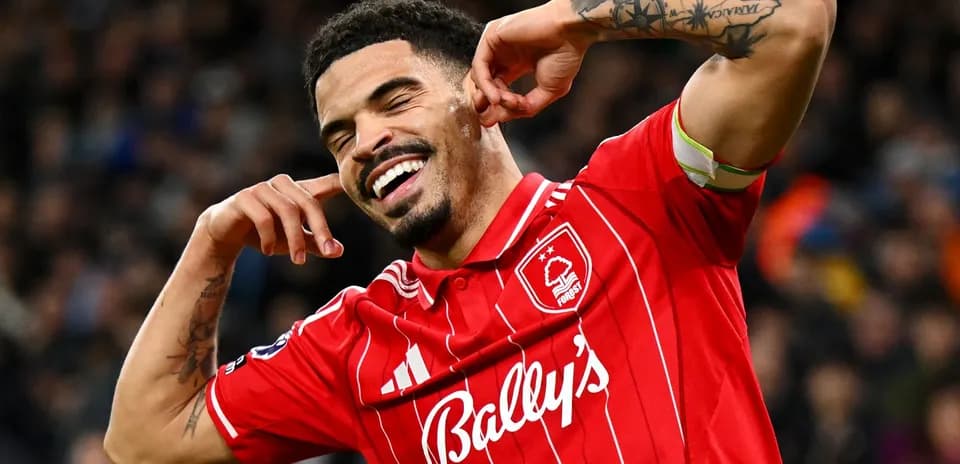 Player celebrating in red jersey after scoring