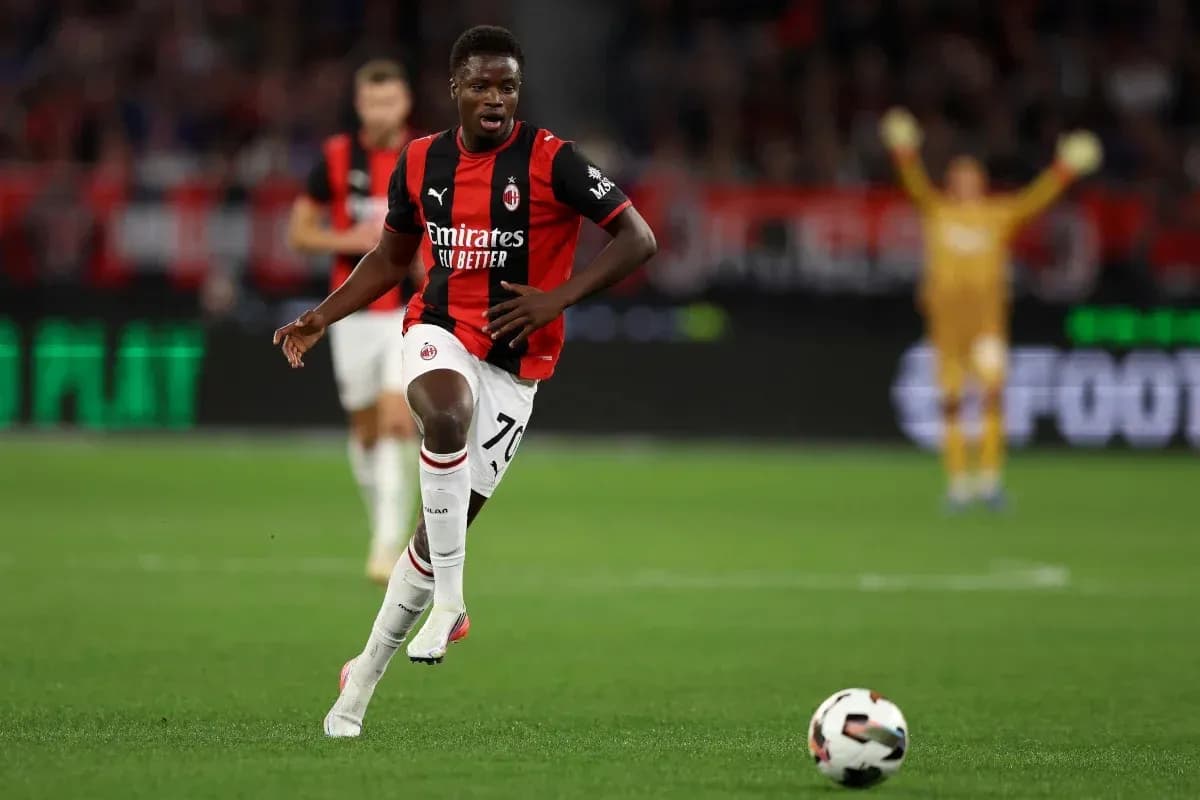 AC Milan player running with ball during match