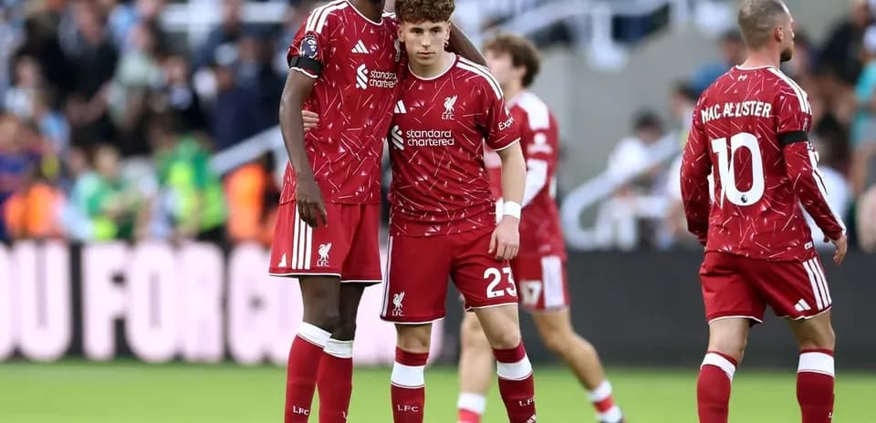 Two Liverpool players discussing on the pitch