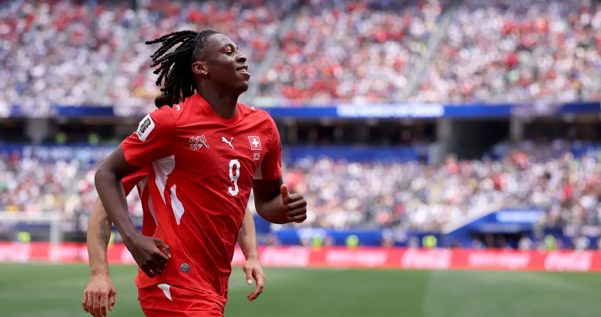 Player in red jersey celebrating during match