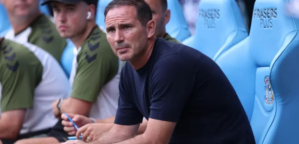 Coach seated on the bench during a match