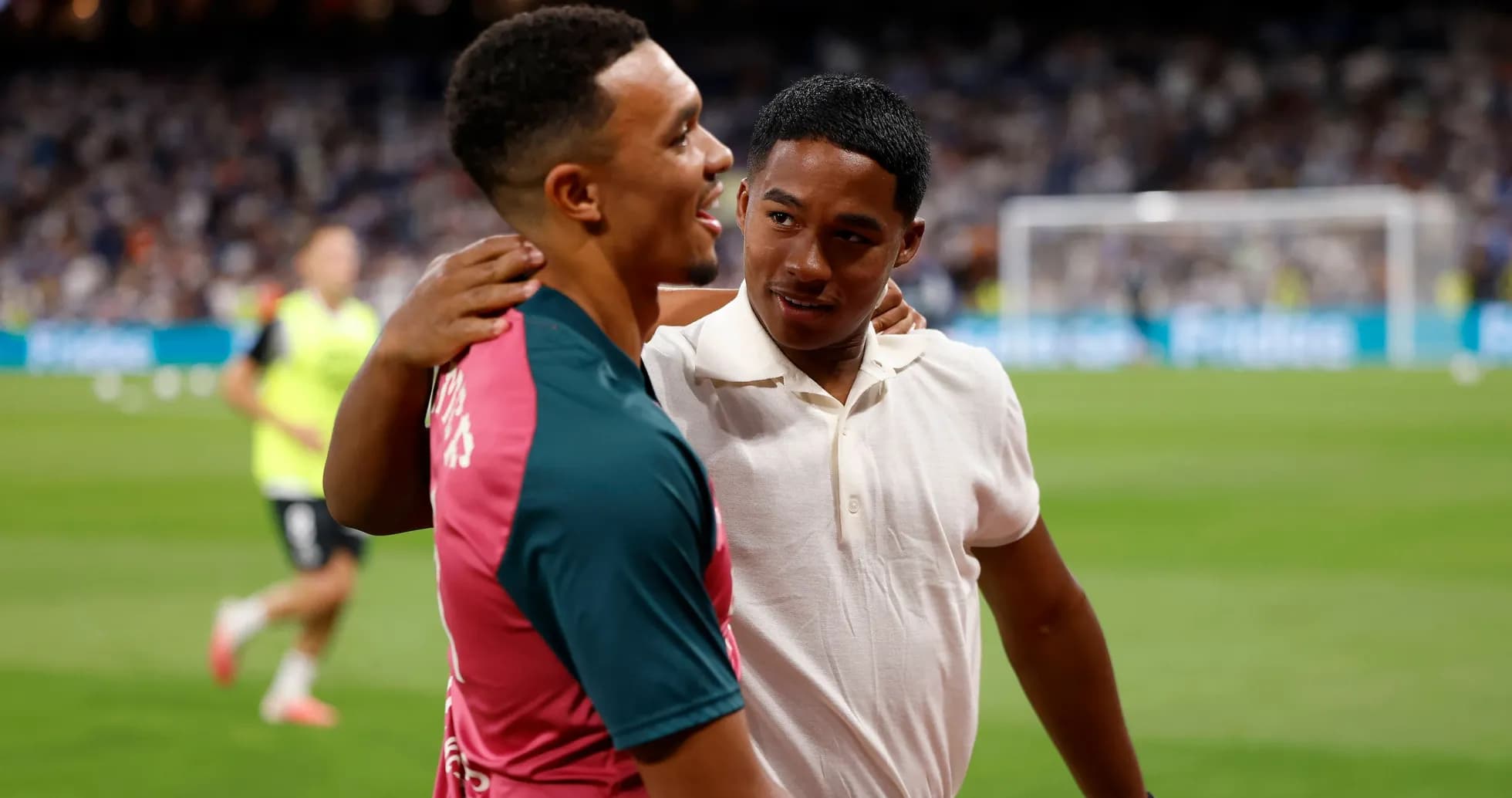 Two players embracing on the field post-match